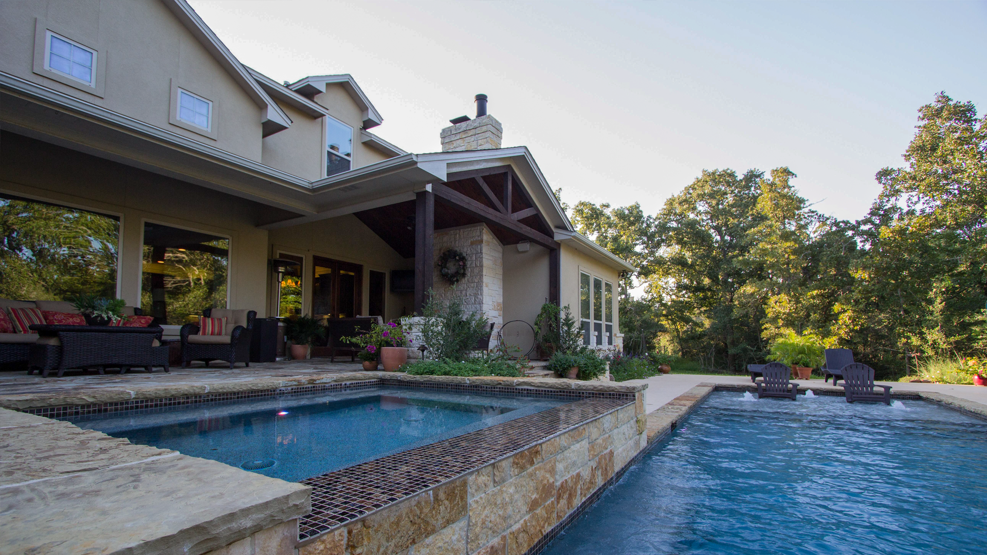 A large house with a large swimming pool in front of it.