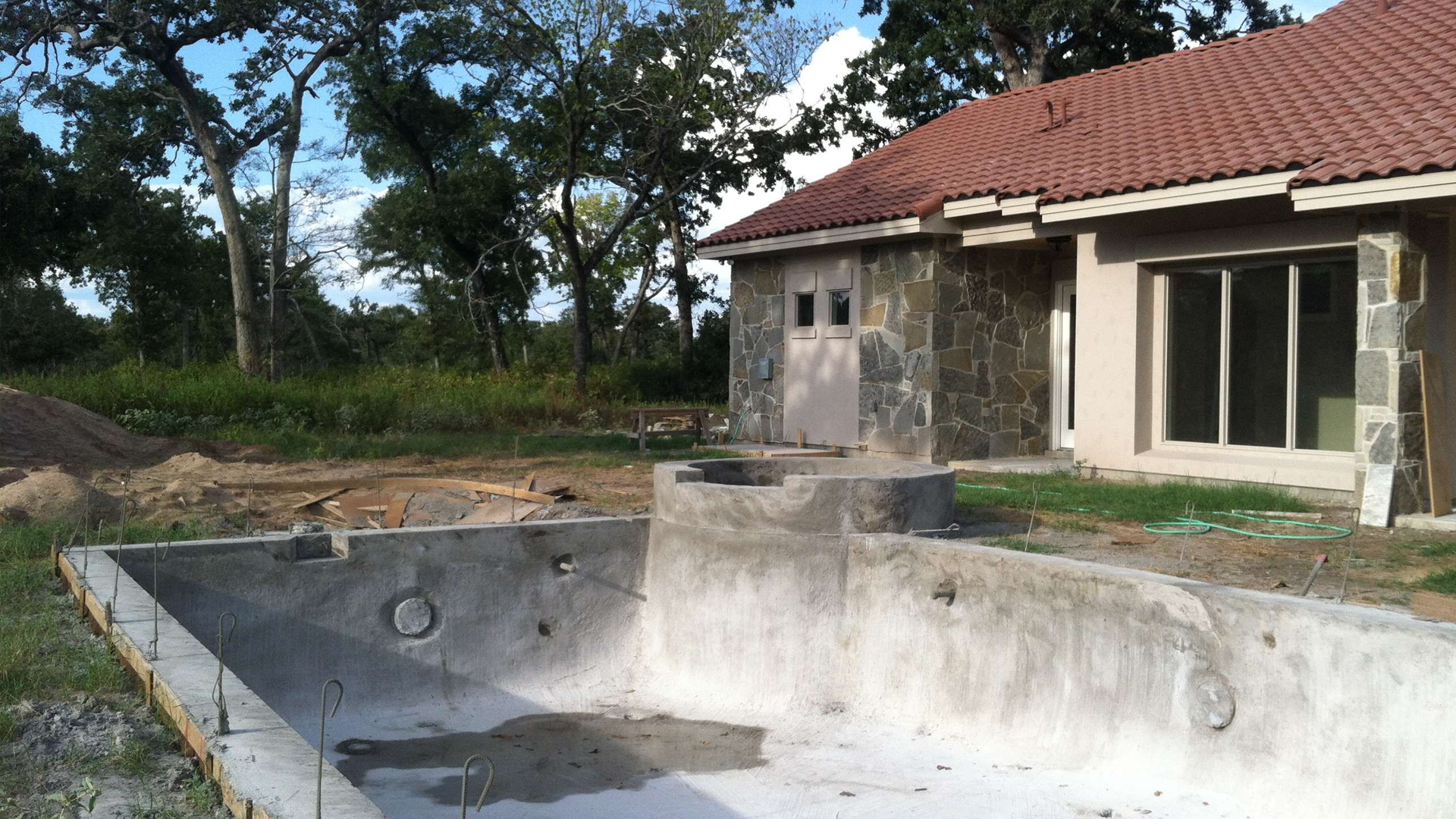 A swimming pool is being built in front of a house