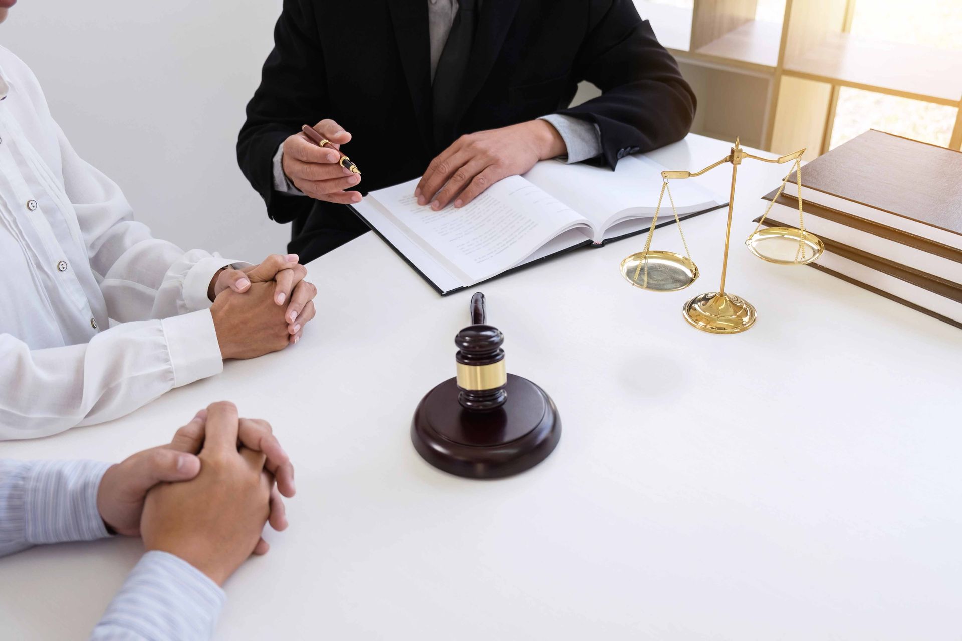 Estate planning lawyer in Boca Raton, FL advising clients on wills and trusts at an office meeting.