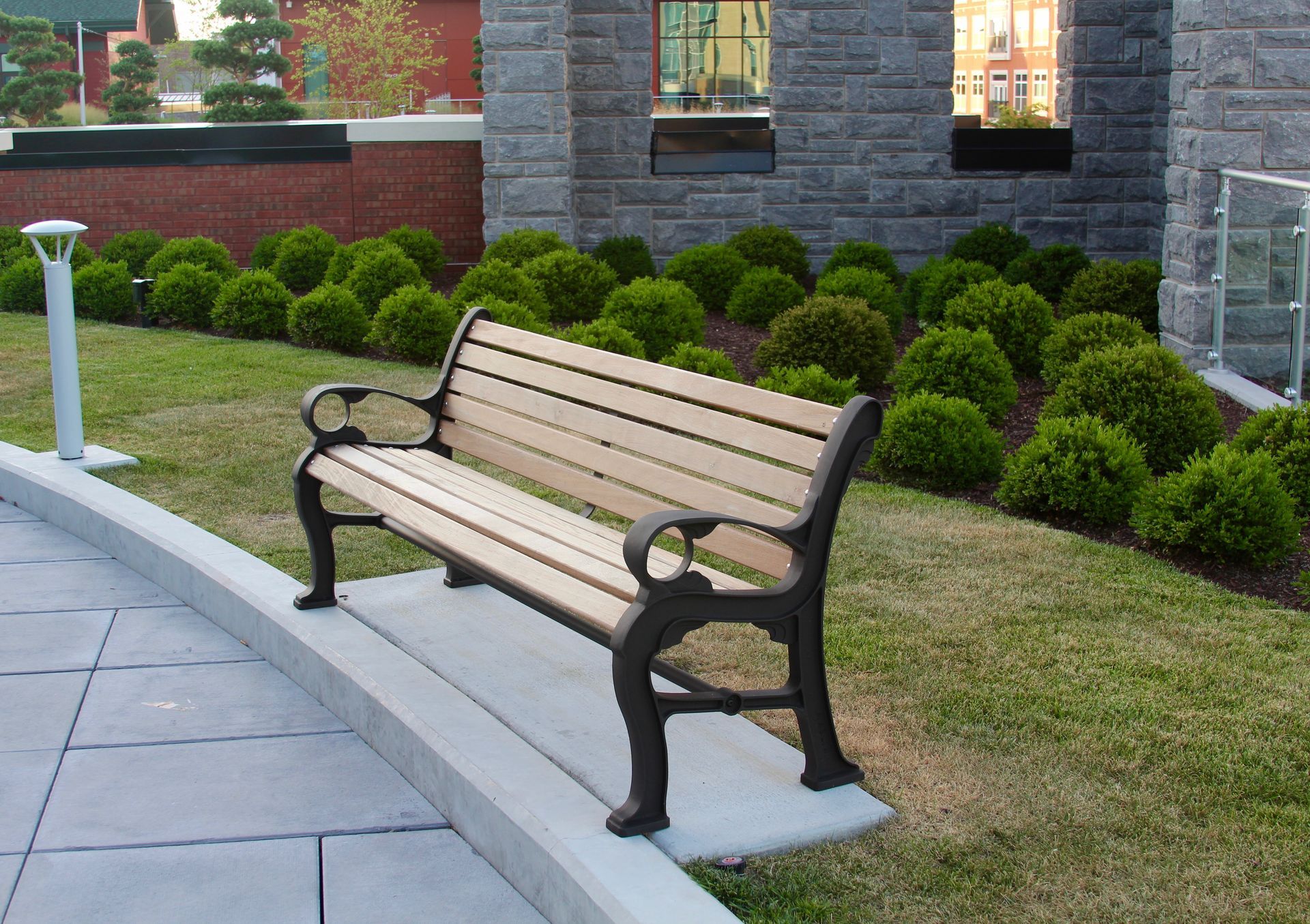A wooden bench sits in front of a brick building