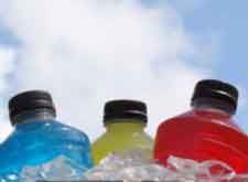 Three colorful sports drinks—blue, yellow, and red—against a cloudy sky.