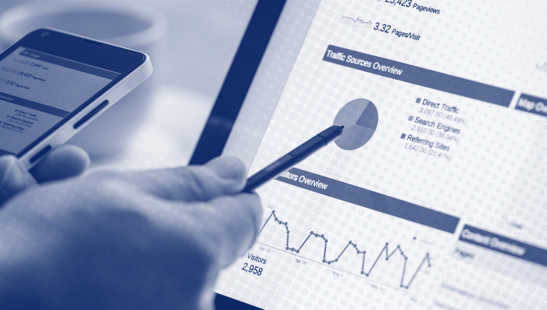 a person is pointing at a graph on a tablet while holding a cell phone .