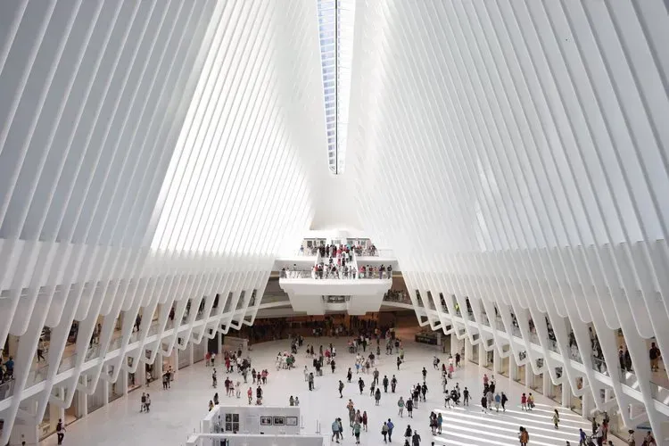 A large white building with a lot of people inside of it.