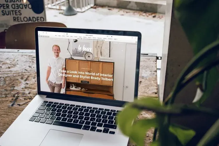 A laptop computer is open to a website on a table.
