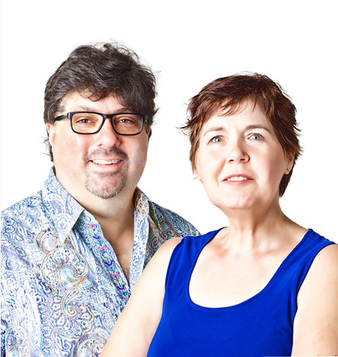 Kellie McCartney, is wearing a blue tank top.  the man, Bryon McCartney, is wearing a decorative blue dress shirt