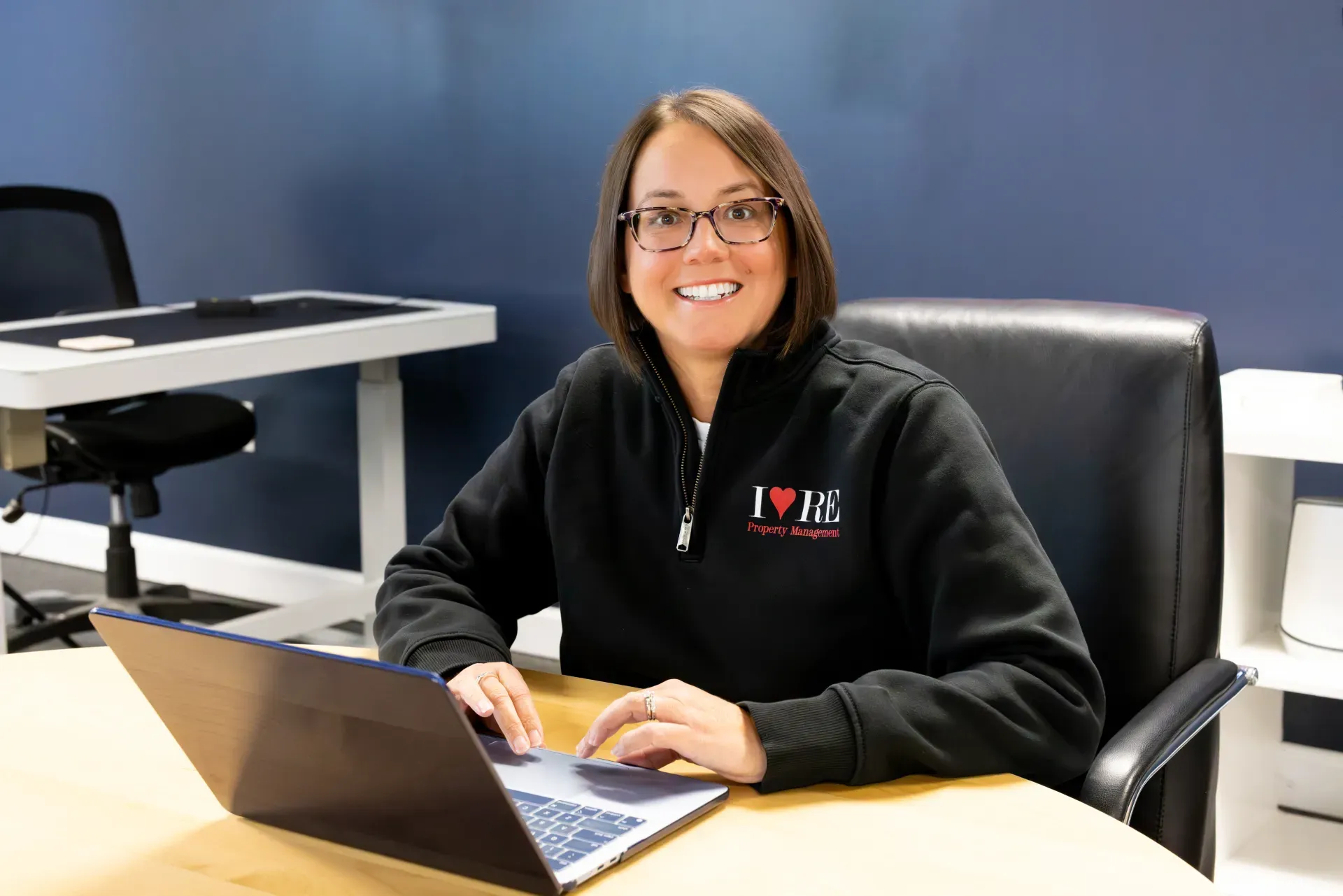 A man with a beard is sitting in front of a laptop computer.
