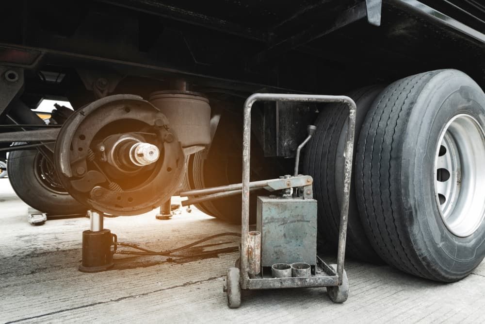 A Truck is Being Repaired With a Jack — Wards Byron Shire Truck & Machinery Centre In Tyagarah, NSW