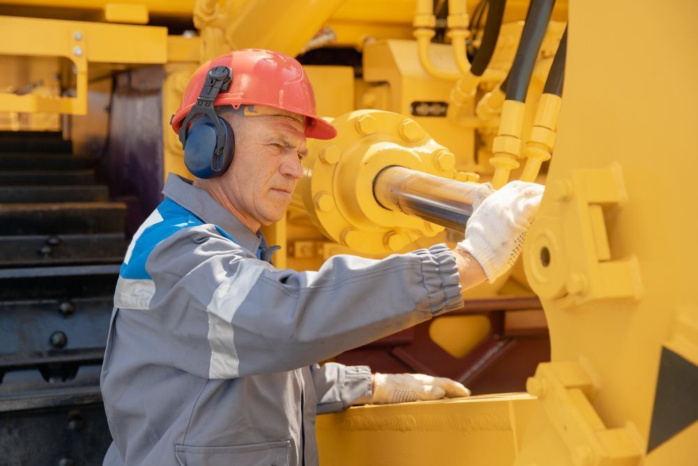 A Man Is Working On A Machinery — Wards Byron Shire Truck & Machinery Centre In Tyagarah, NSW