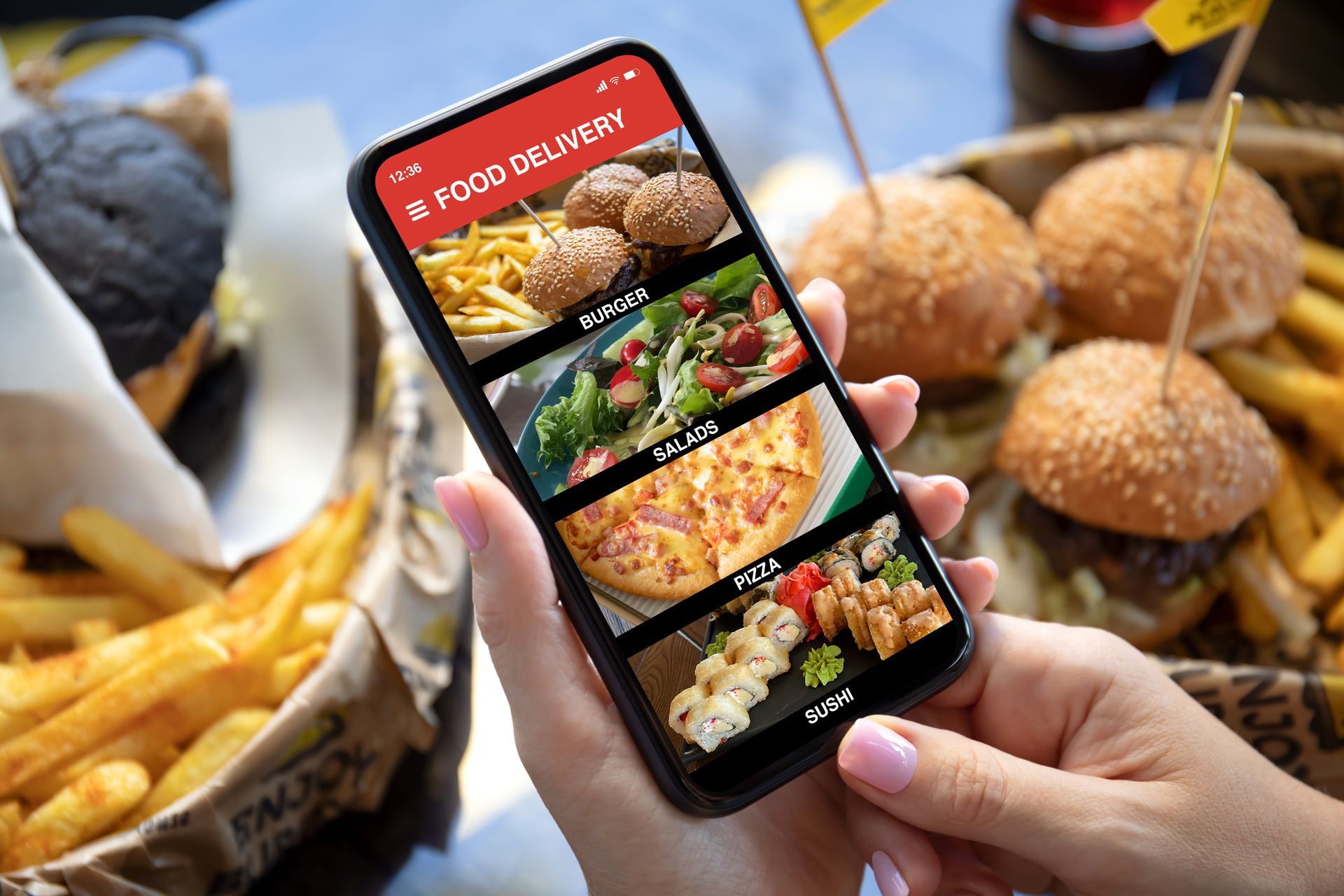 A person is holding a cell phone with a food delivery app on it.