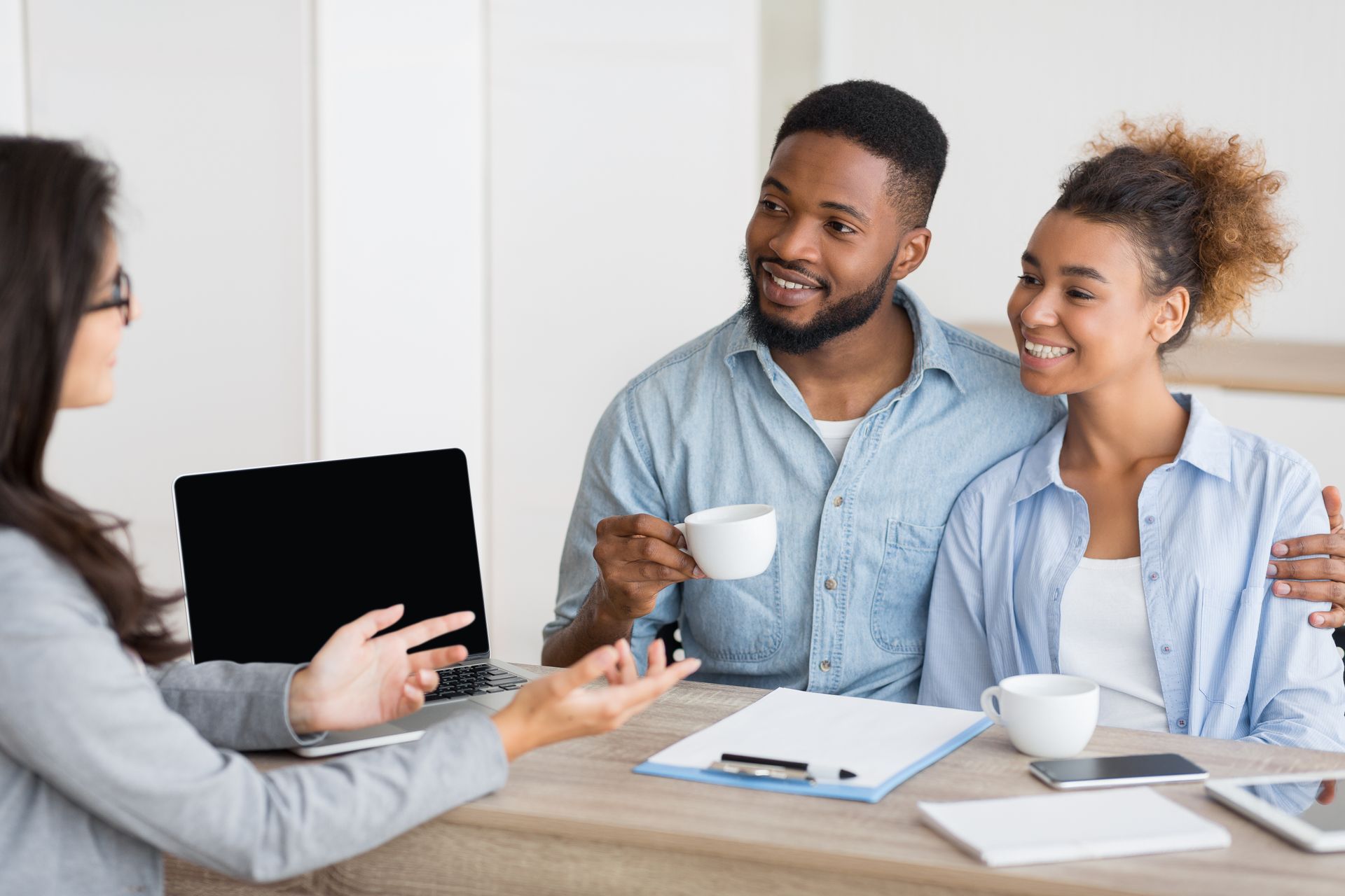 a man and woman are sitting at a table talking to a woman .