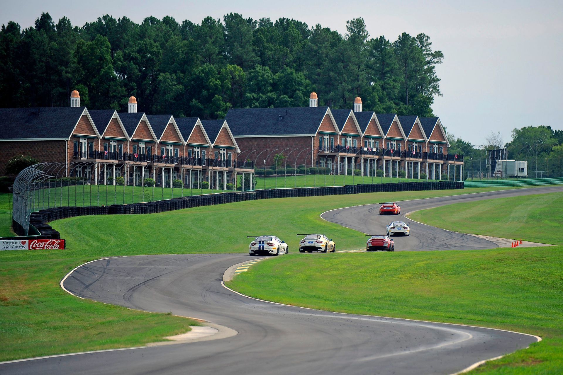 A race track with a row of houses in the background
