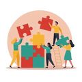Four people work together to assemble a large, colorful jigsaw puzzle on a circular background.