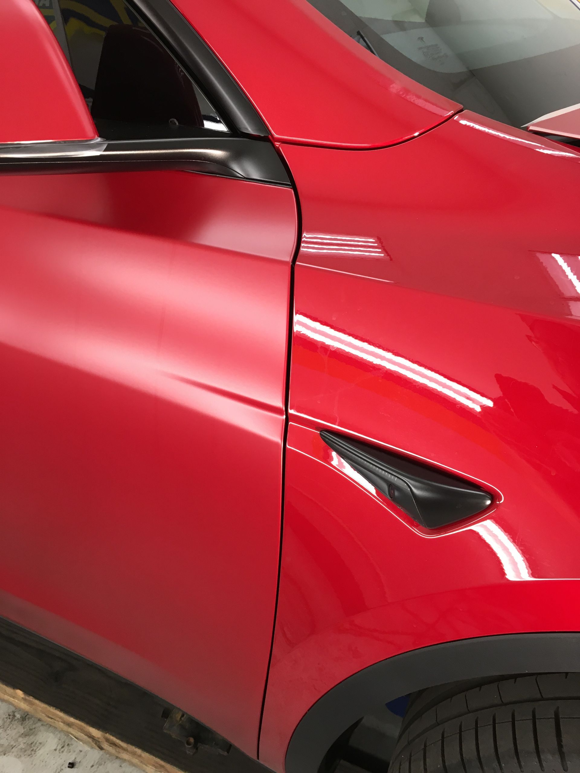 A close up of a red car with the door open