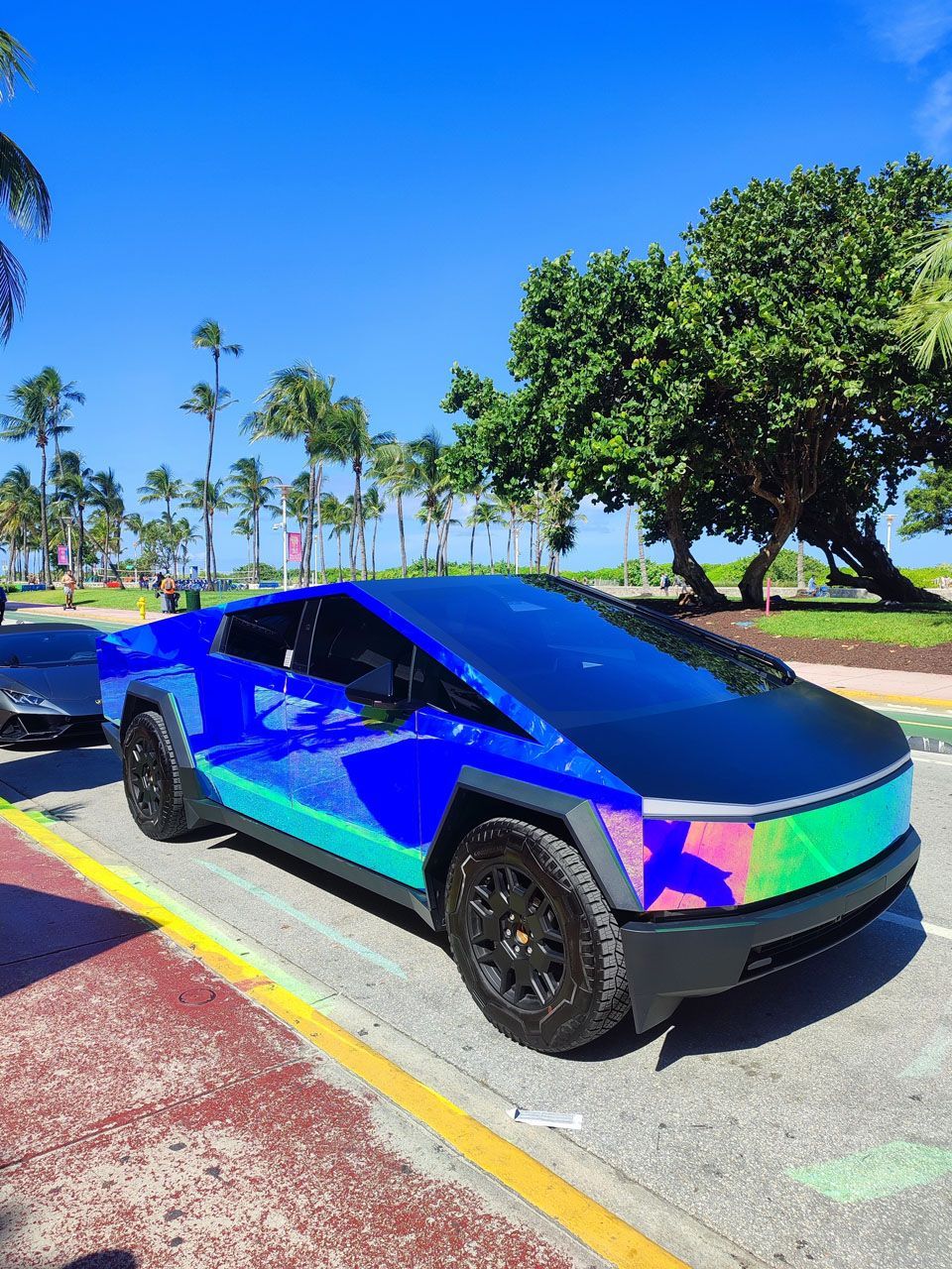 A tesla cybertruck is parked on the side of the road.