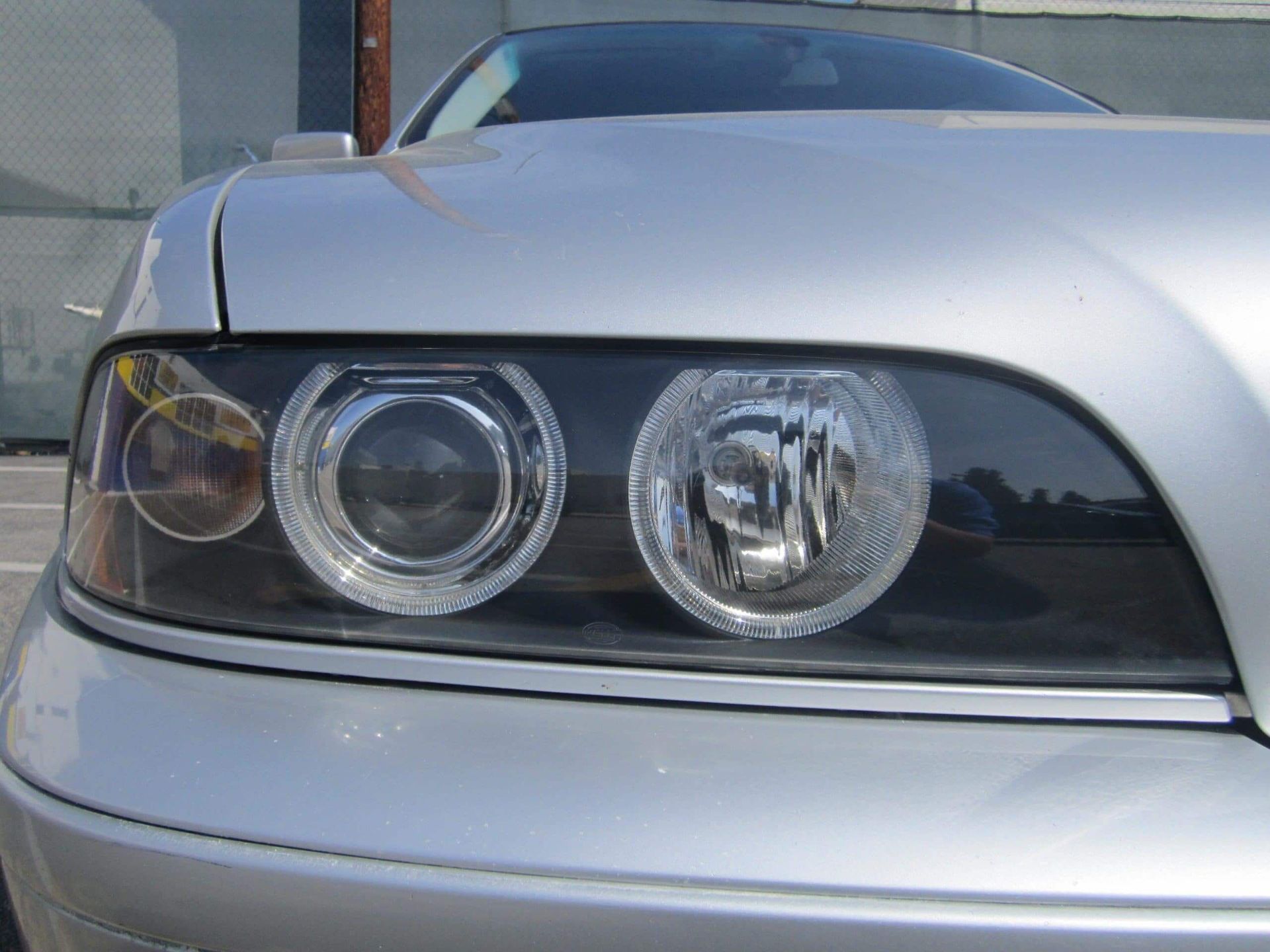 A close up of the headlights of a silver car