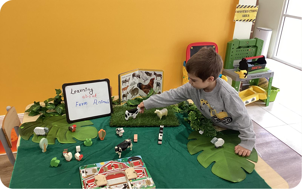 Children enjoying an outdoor learning activity at Kinder Academy