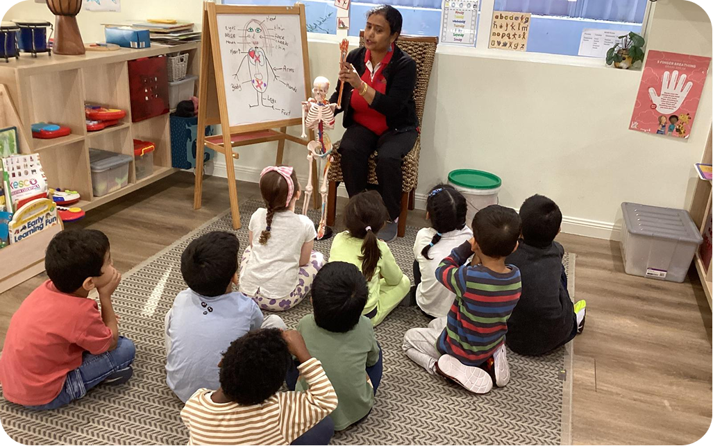 Children enjoying outdoor play with an educator at Kinder Academy