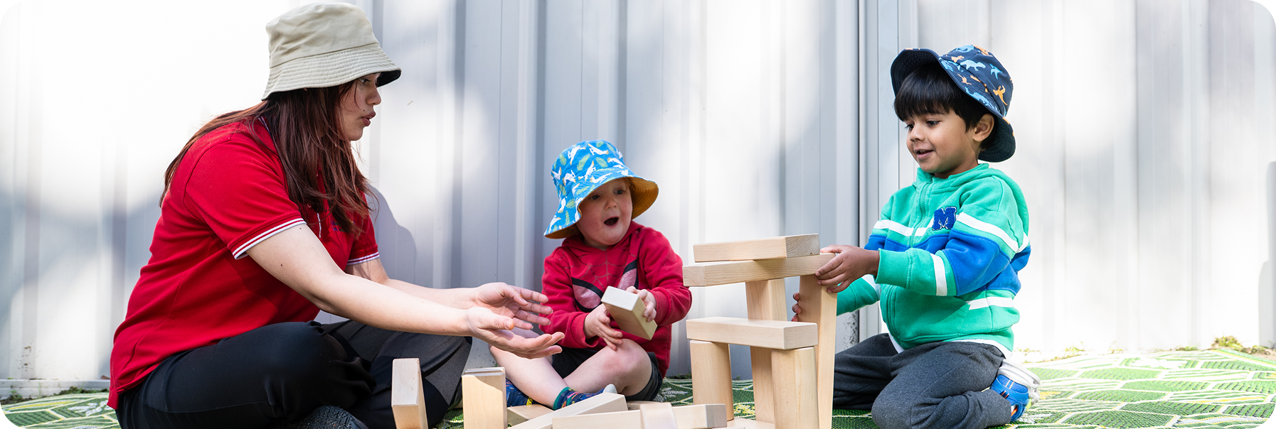 Children building with wooden blocks at Kinder Academy