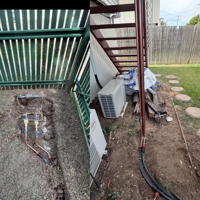 Trenching and exposed utility cables beside a house and fence in a backyard.