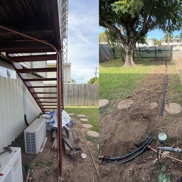 Backyard with exposed trench and black cables beside an outdoor staircase and AC unit