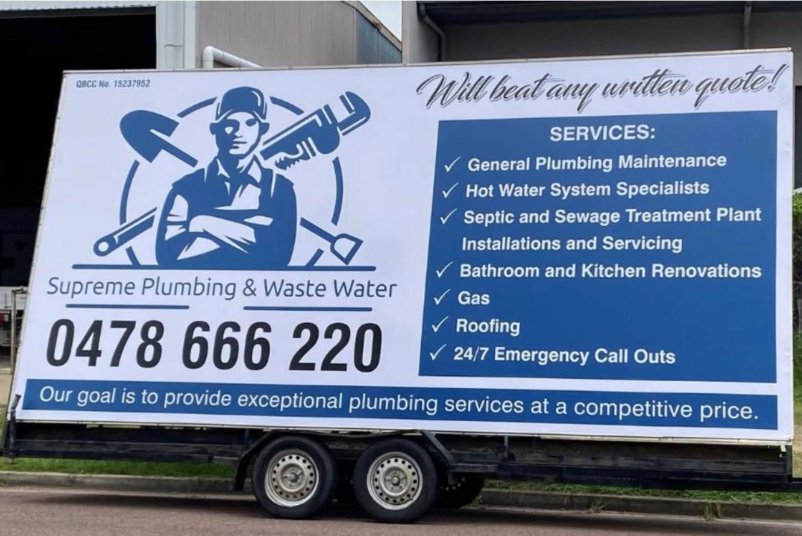 Plumbing service truck with blue and white advert, “Supreme Plumbing & Waste Water,” on a trailer