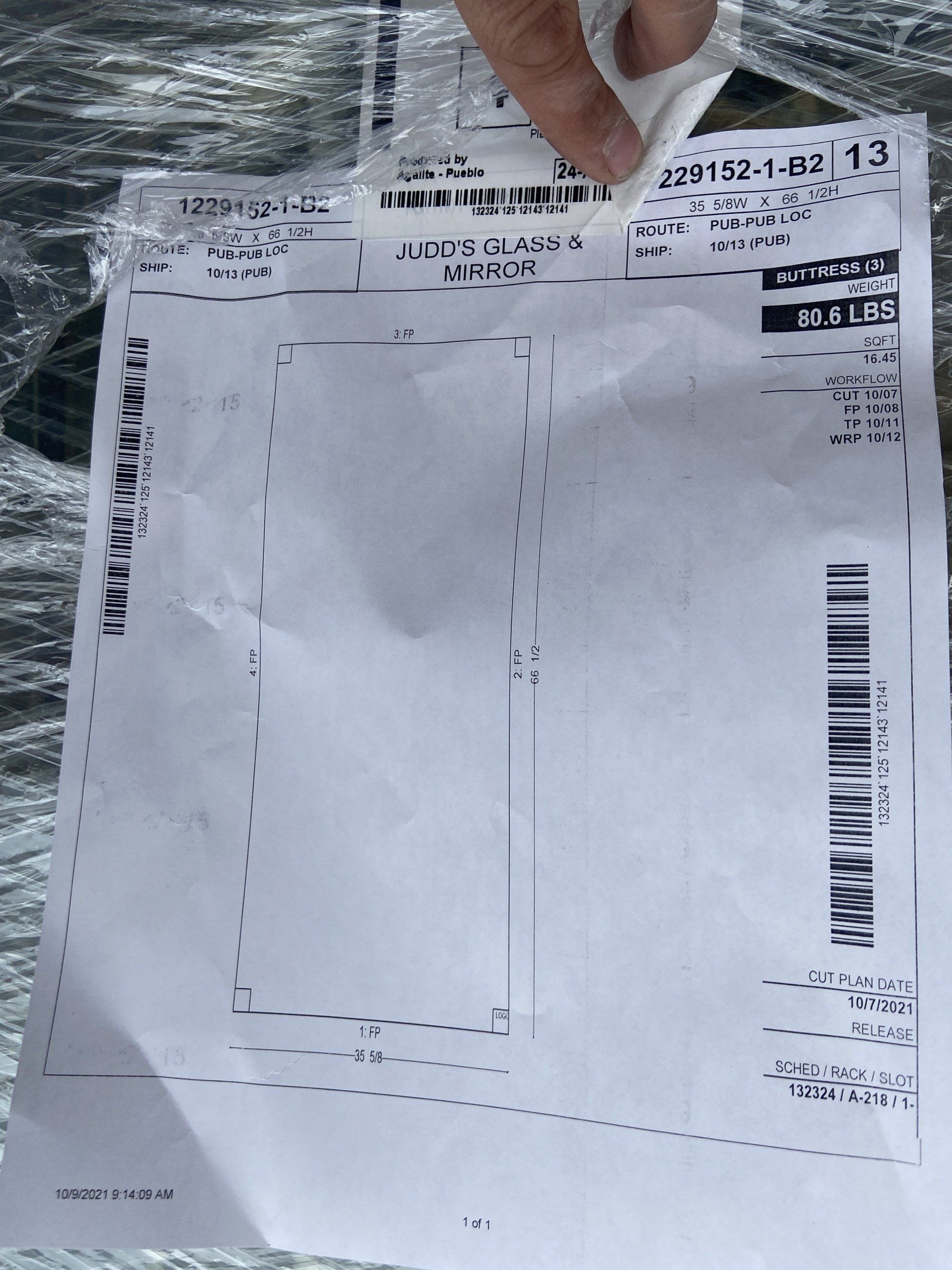 A person is holding a piece of paper with the number 13 on it