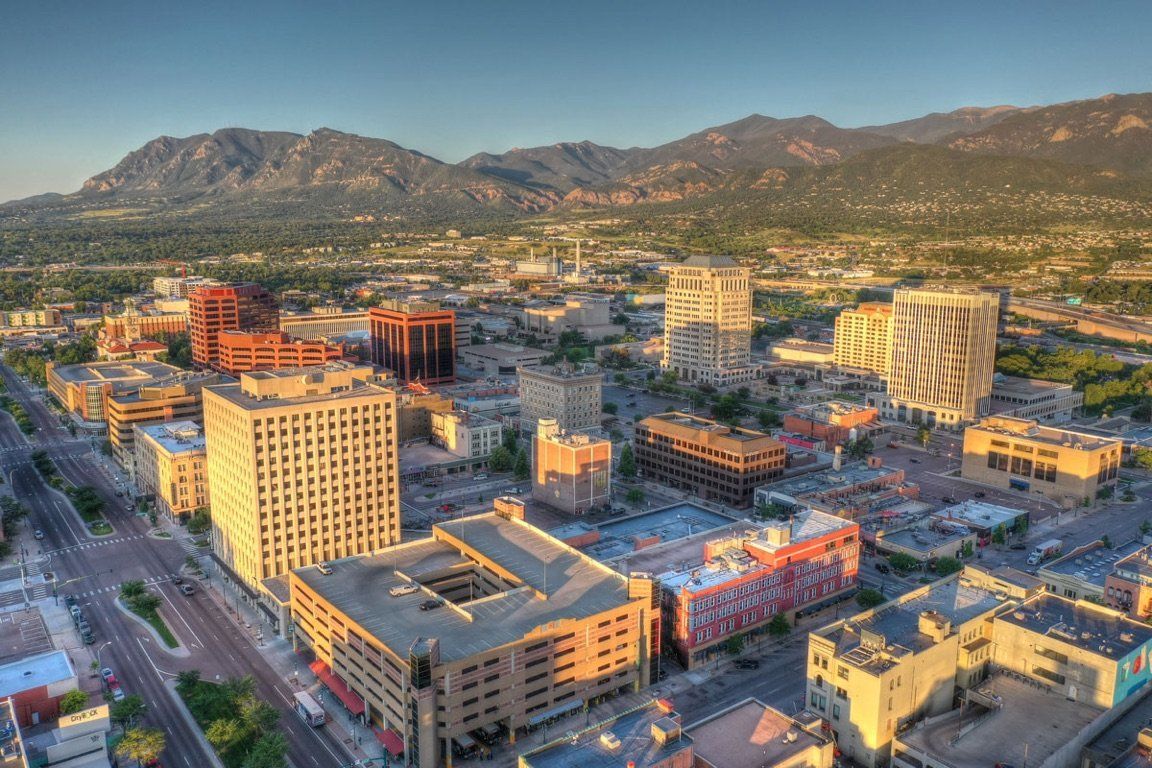 An aerial view of a city with mountains in the background.