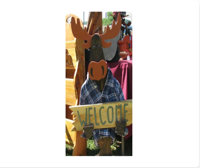 Wooden moose carving holding a