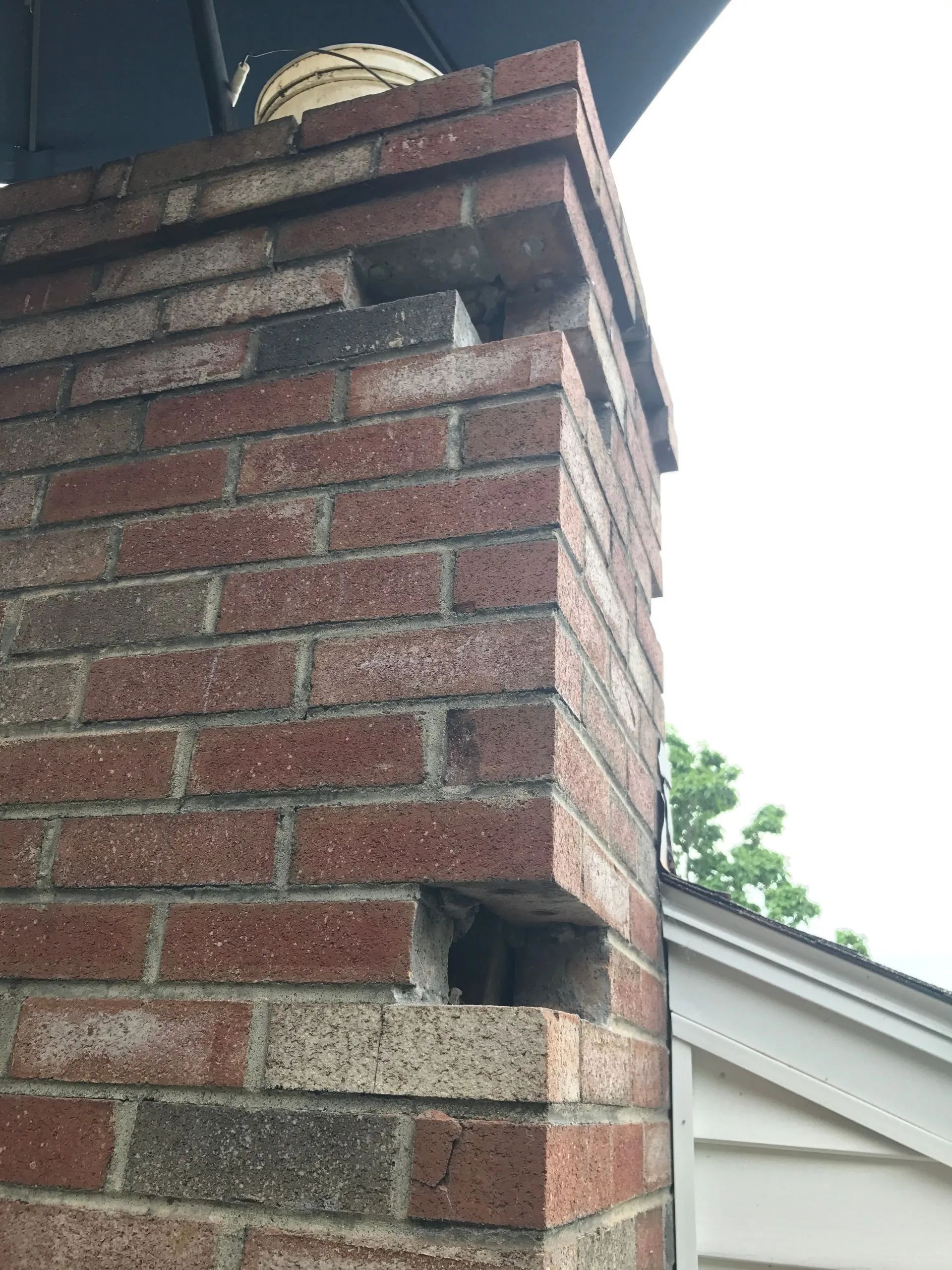 A chimney made of bricks being fixed.