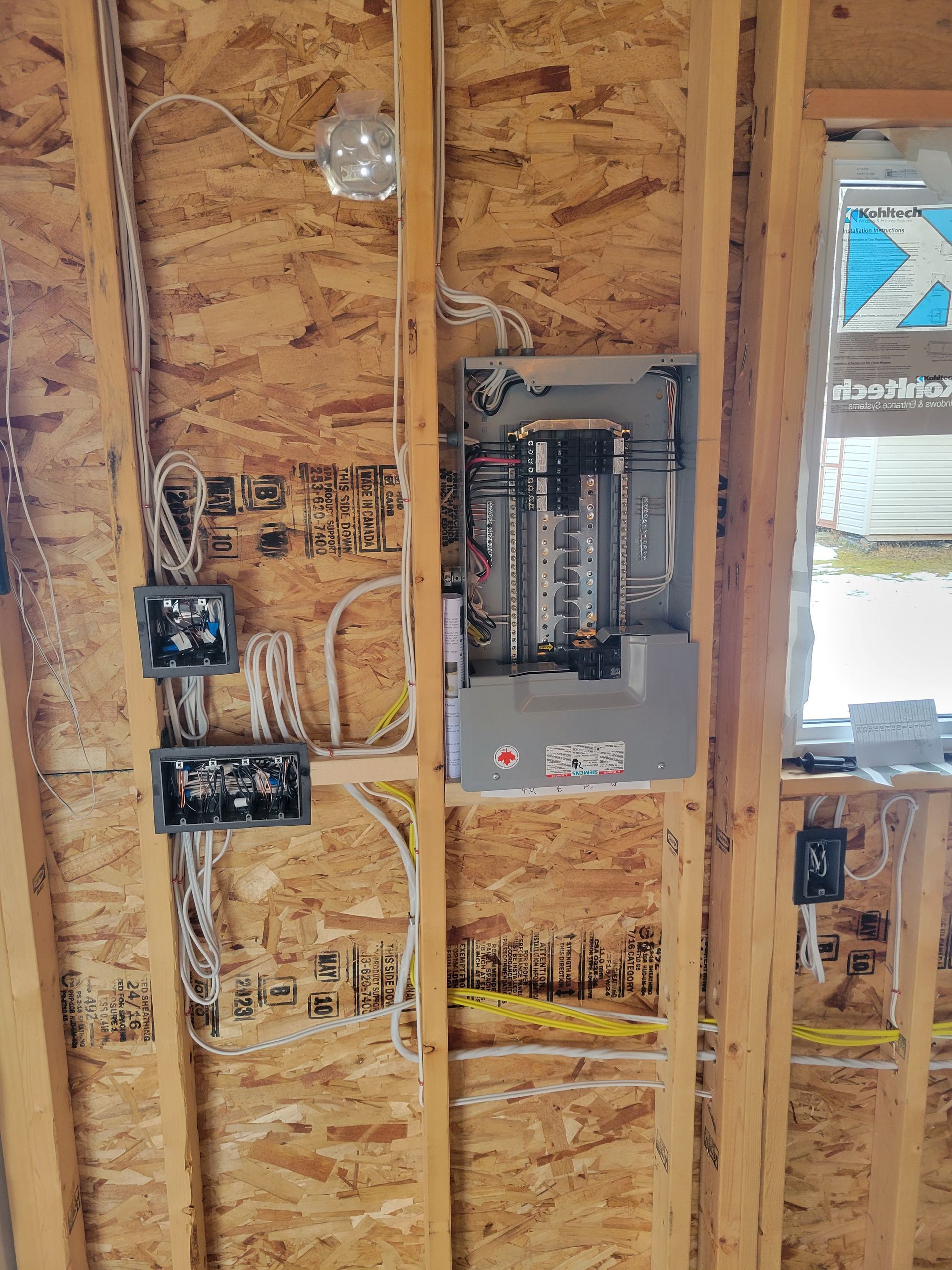Open electrical panel and new wiring during rough-in in an Edmonton home