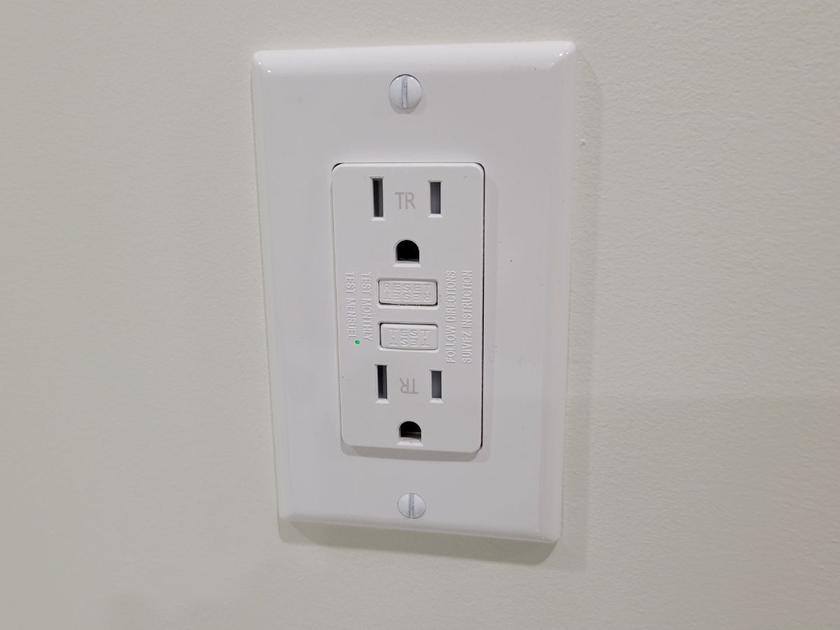 New GFCI outlet installed on a finished wall in an Edmonton home