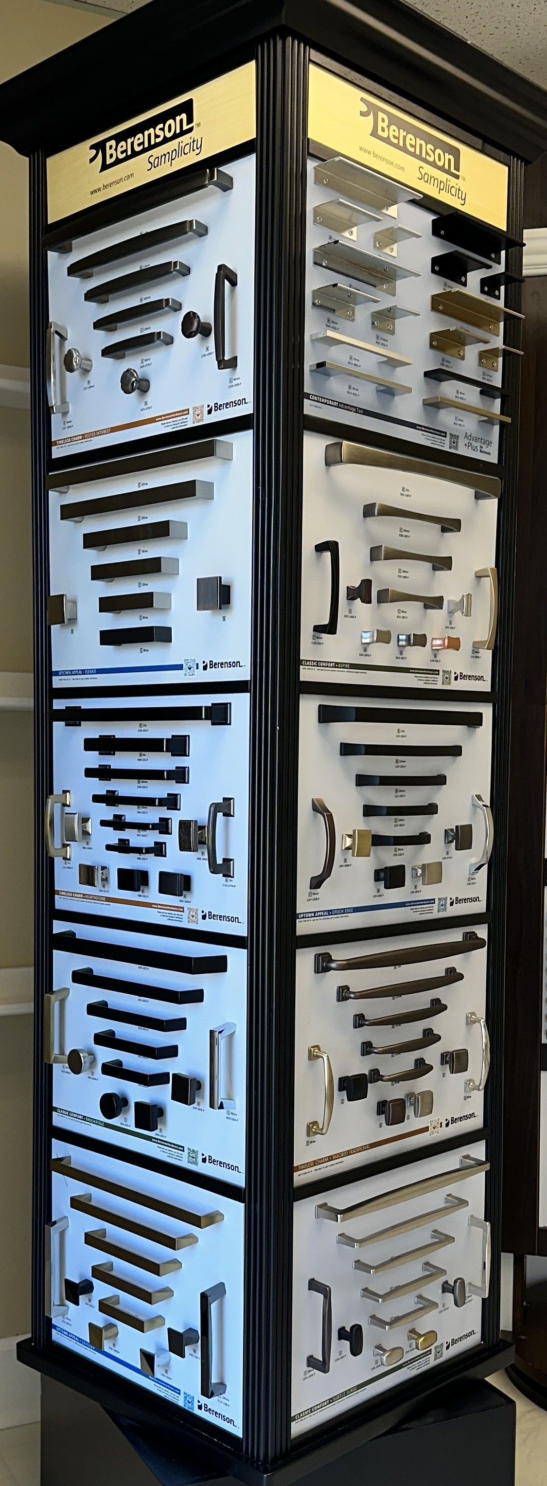 A rotating display showcasing cabinet handles and knobs in a showroom.