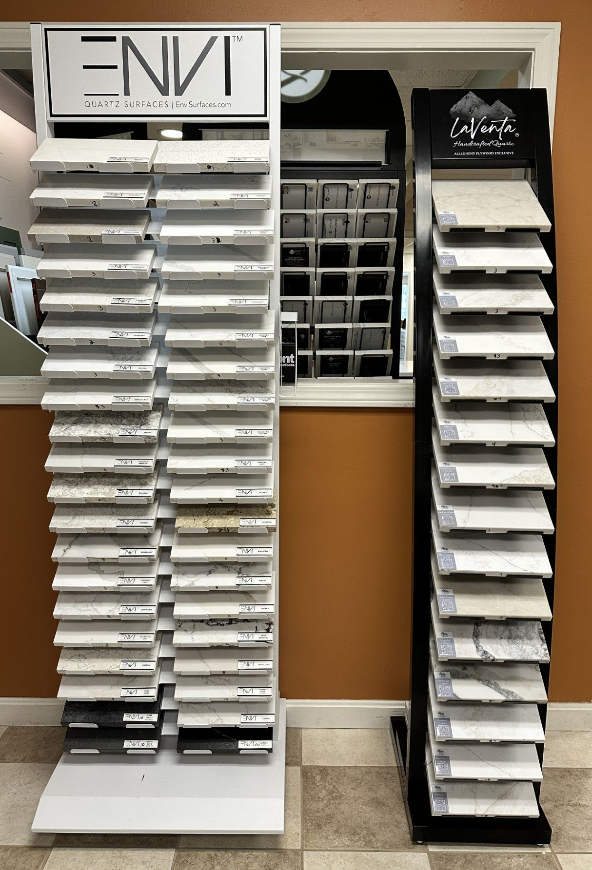 Two vertical displays of countertop samples in a showroom setting.