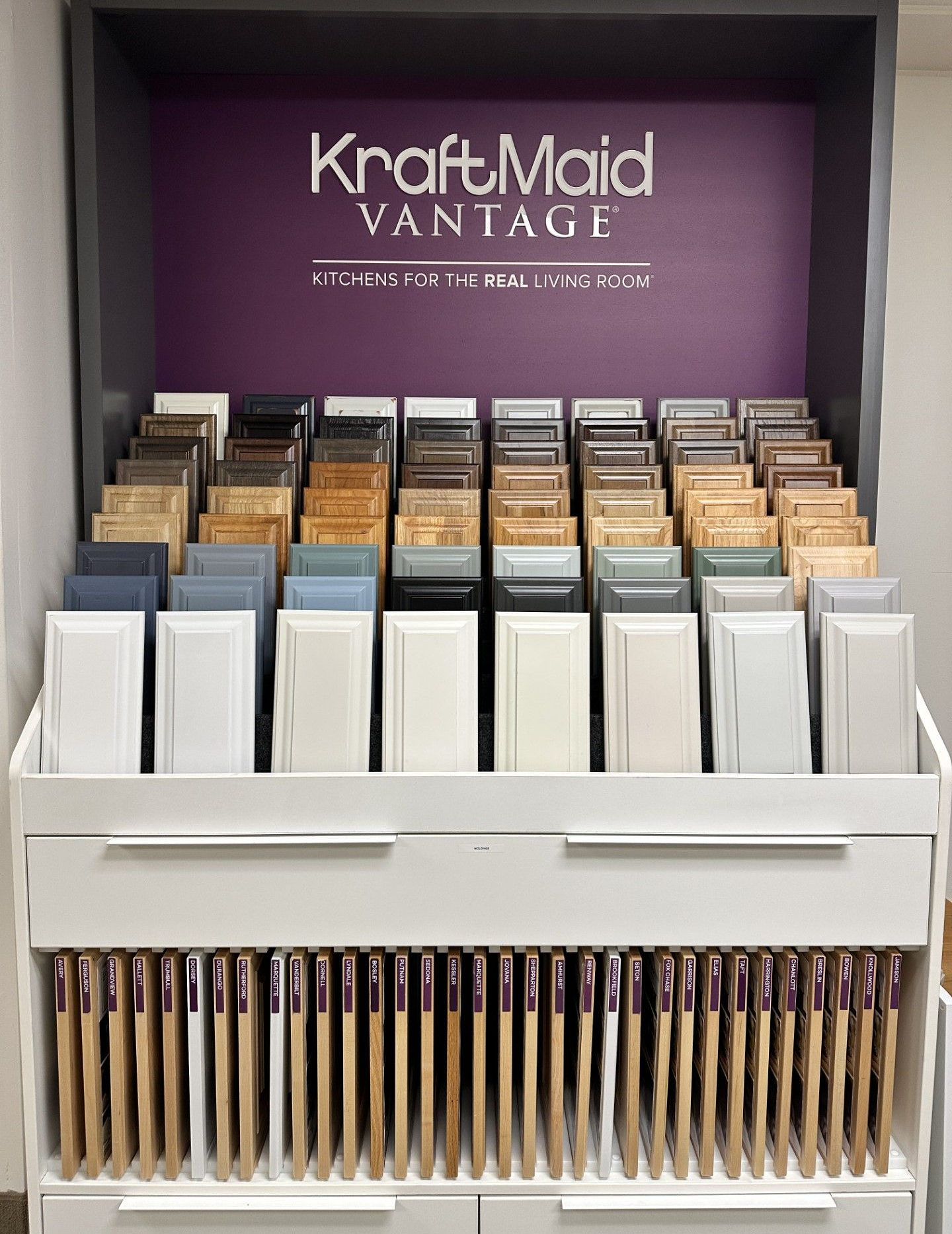 Display of KraftMaid Vantage cabinet samples in various colors and finishes.