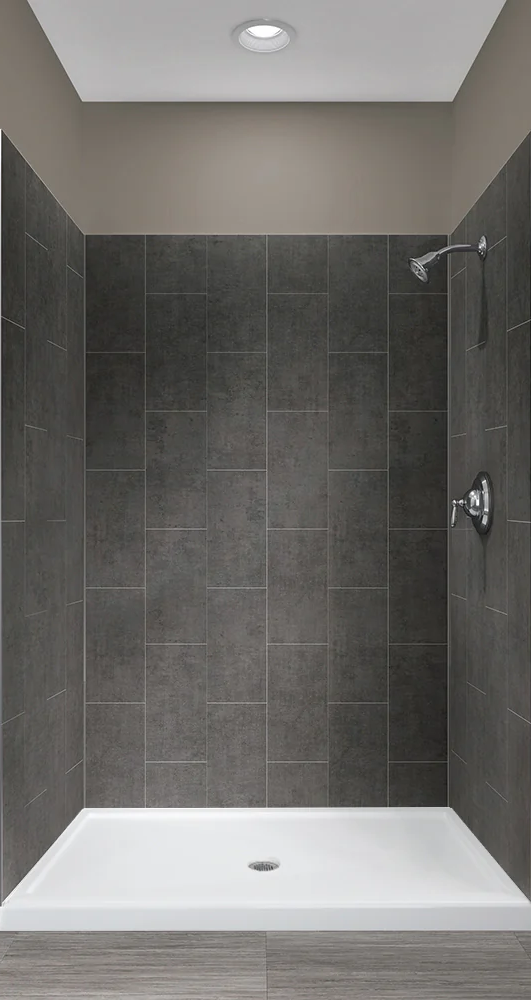 Dark tiled shower with white base and fixtures.