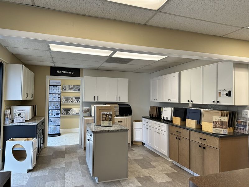 Kitchen cabinetry showroom featuring various cabinet styles and countertops.