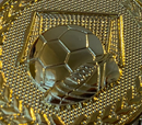 A metallic soccer ball embossed on a gold textured background