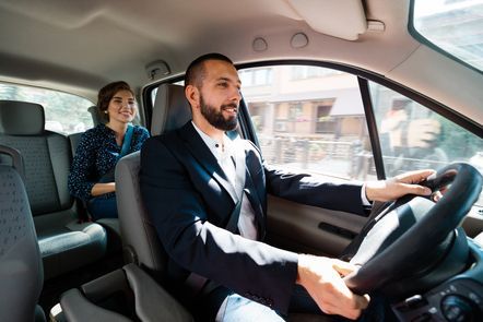 Driver with a female passenger in the backseat.
