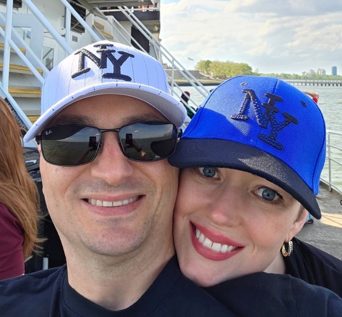 A man and woman wearing hats are posing for a picture