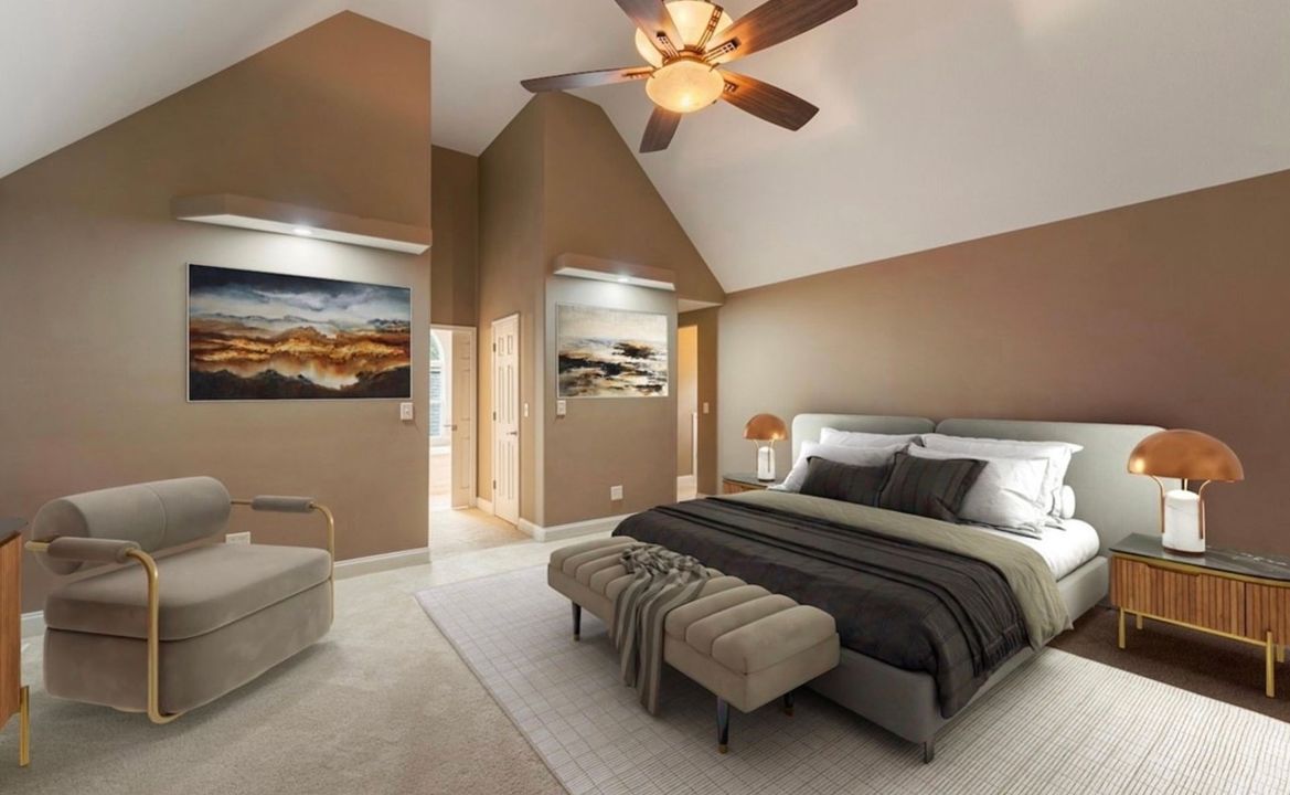 Modern bedroom with vaulted ceiling, king bed, bench, chair, and warm tan walls