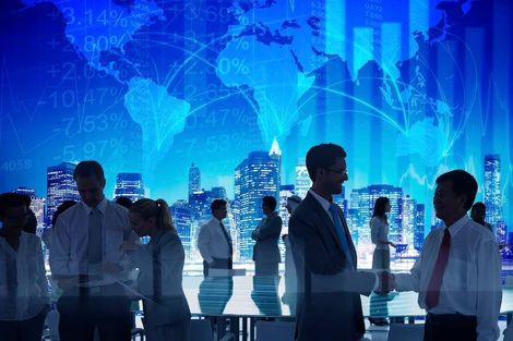 A group of business people are shaking hands in an office.