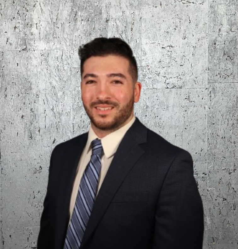 A man in a suit and tie is smiling for the camera.