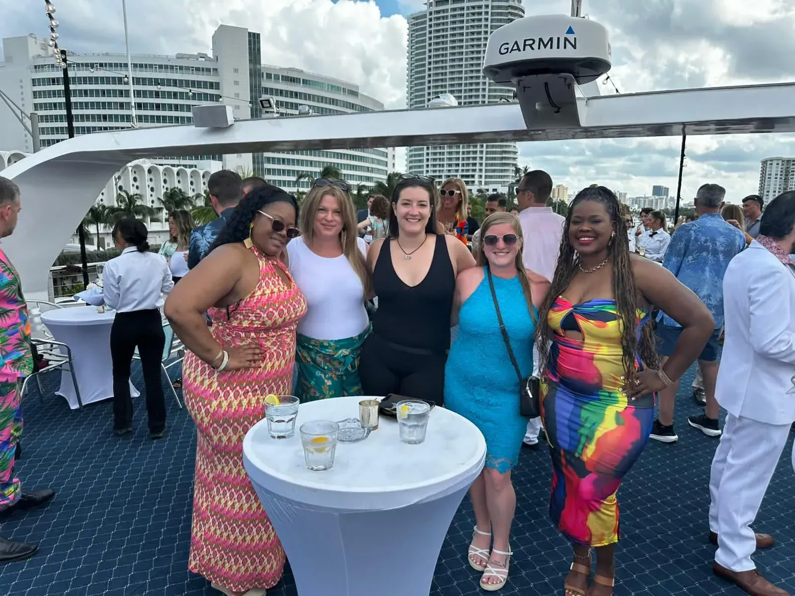 A group of women are posing for a picture on a boat.