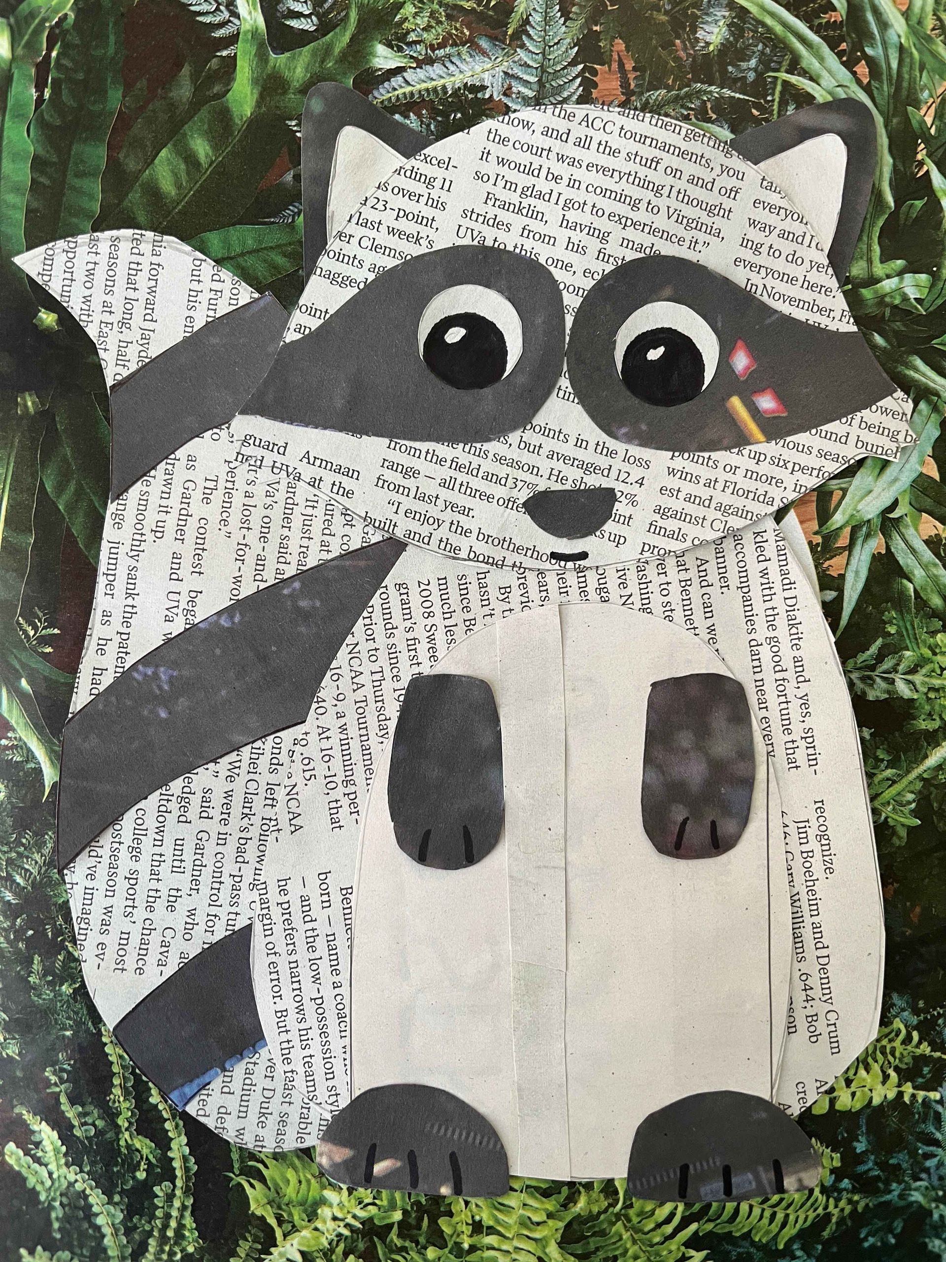 Papercraft raccoon with black and white stripes and spots, in a forest setting.