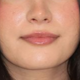 A close up of a woman 's lips and nose.