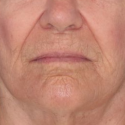 69 year old female posing in front of a blue background 