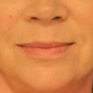 43 year old female in front of a blue background