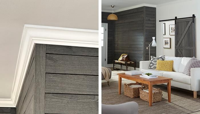 Room with wood paneled wall, white crown molding, and living room furniture.