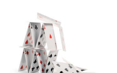 A house of cards, some cards are falling, against a white background.