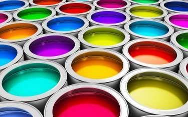Open paint cans filled with various bright colors.